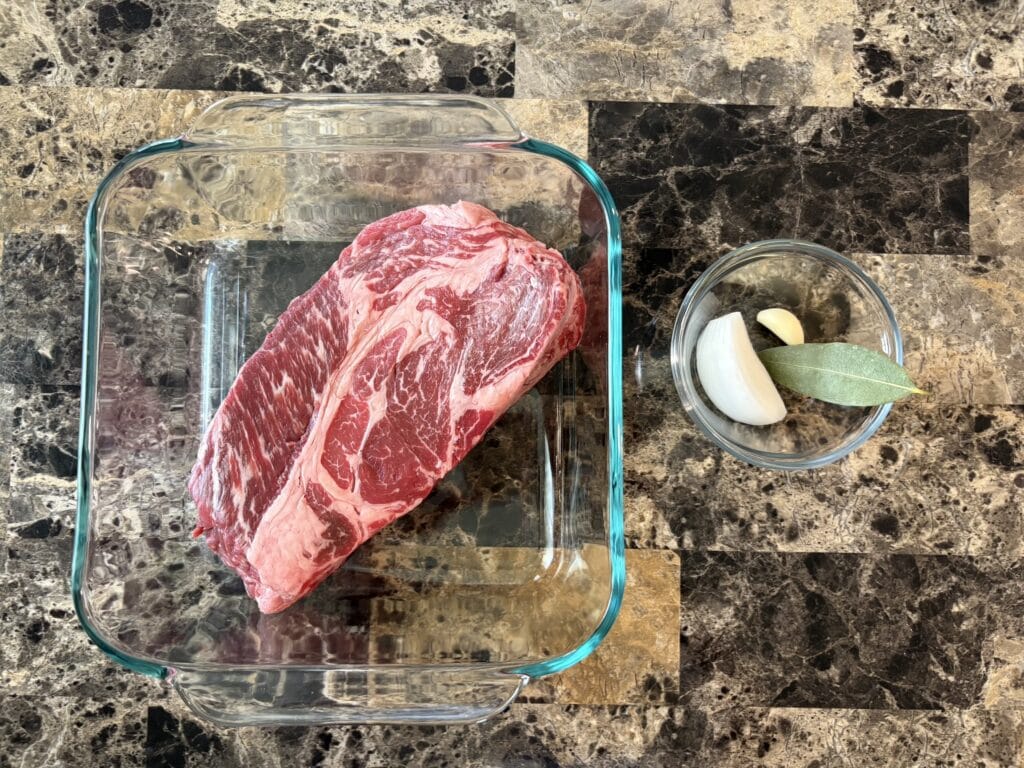 Top view of beef barbacoa ingredients on a table.