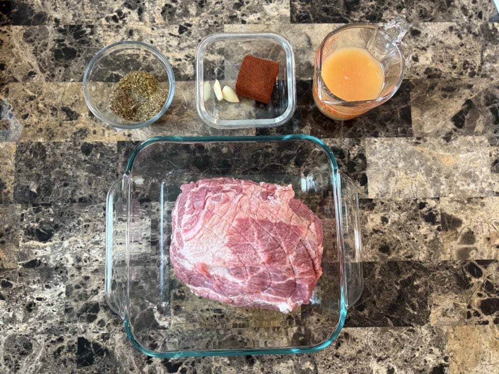 Top view of cochinita pibil ingredients on a table.