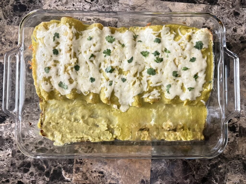 Top view of enchiladas suizas in baking dish after they are baked.