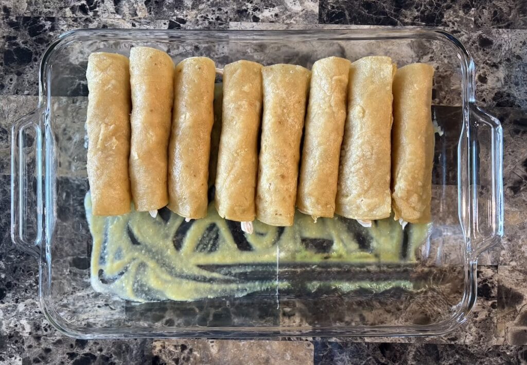 Top view of rolled tortillas in baking dish.