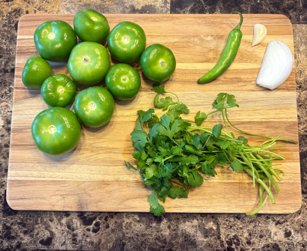 Salsa verde ingredients on a cutting board.