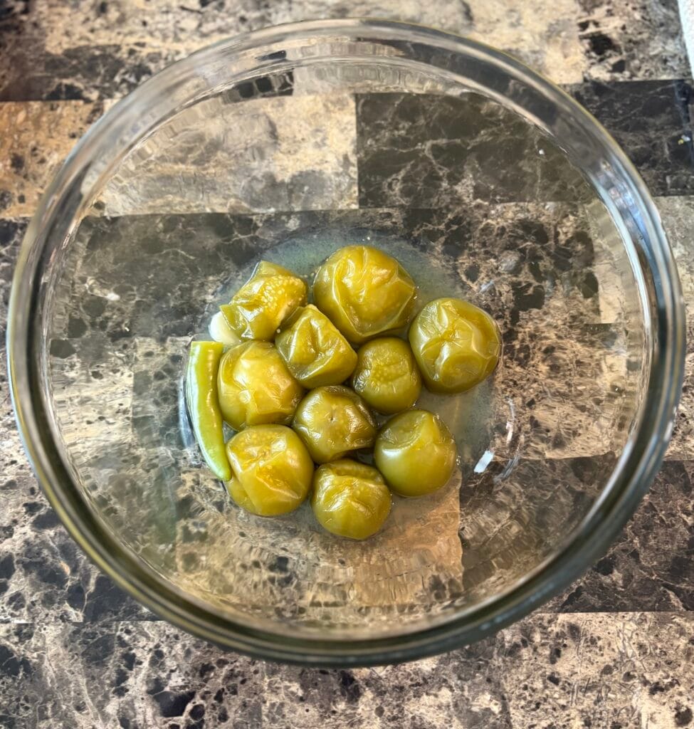 Salsa verde ingredients in a glass bowl after they were simmered.