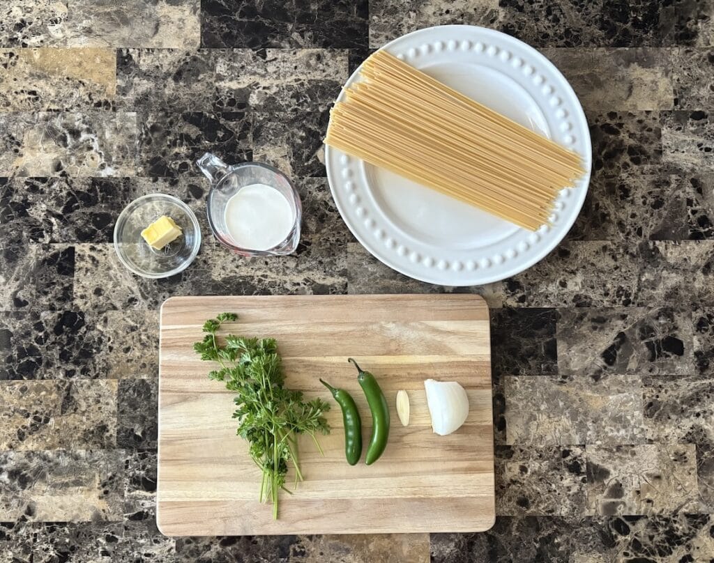 Top view of espagueti verde ingredients on a table.