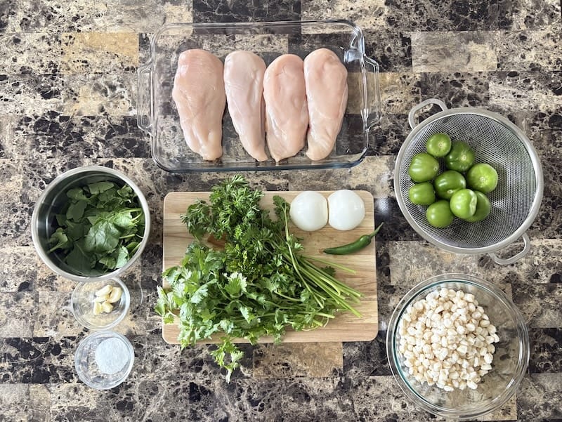 Top view of pozole verde ingredients set on a table.