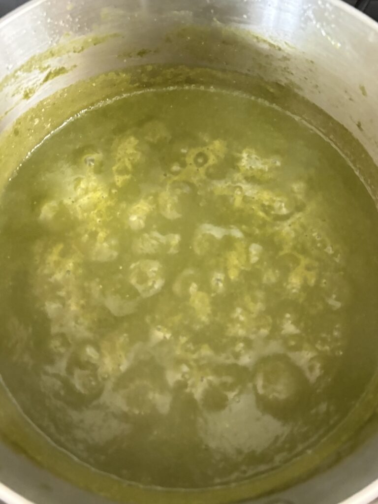 Top view of pozole verde salsa simmering.